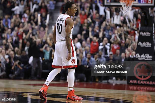 Toronto Raptors guard DeMar DeRozan celebrates a clutch basket by Kyle Lowry as the Toronto Raptors beat the Utah Jazz 101-93 at Air Canada Centre in...