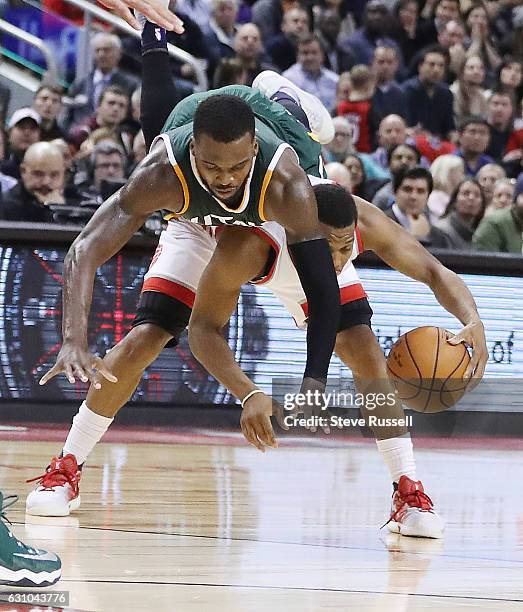 Utah Jazz guard Shelvin Mack fouls Toronto Raptors guard Kyle Lowry flying right over him as the Toronto Raptors beat the Utah Jazz 101-93 at Air...