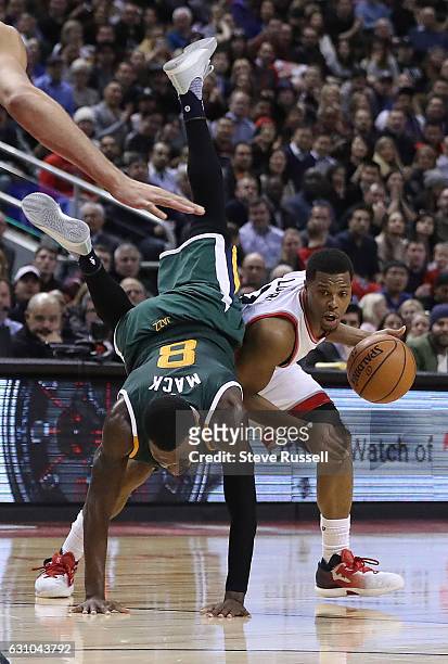Utah Jazz guard Shelvin Mack fouls Toronto Raptors guard Kyle Lowry flying right over him as the Toronto Raptors beat the Utah Jazz 101-93 at Air...