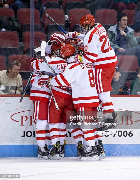 Jakob Forsbacka Karlsson of the Boston University Terriers celebrates his first of three goals against the Union College Dutchmen with his teammates...