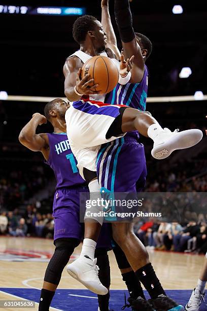 Reggie Jackson of the Detroit Pistons passes around the defense of Roy Hibbert of the Charlotte Hornets at the Palace of Auburn Hills on January 5,...