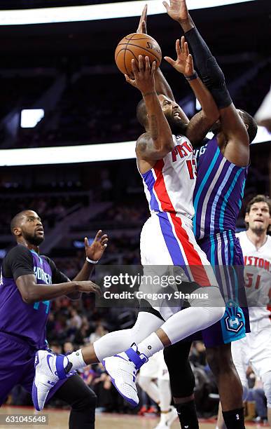 Marcus Morris of the Detroit Pistons tries to get a shot off over Roy Hibbert of the Charlotte Hornets during the second half at the Palace of Auburn...