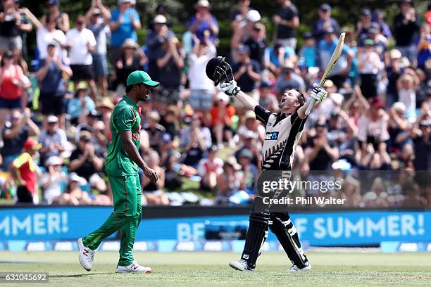 Colin Munro of the Black Caps celebrates his century during the second T20 international between New Zealand and Bangladesh at the Bay Oval on...