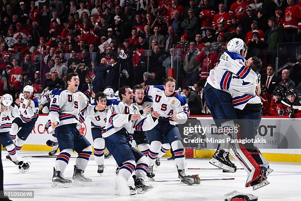 Team United States celebrate as they win gold against Team Canada during the 2017 IIHF World Junior Championship gold medal game at the Bell Centre...