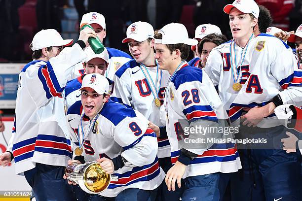 Team captain Luke Kunin of Team United States skates off with the IIHF trophy during the 2017 IIHF World Junior Championship gold medal game against...