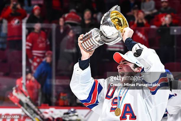 Team captain Luke Kunin of Team United States skates off with the IIHF trophy during the 2017 IIHF World Junior Championship gold medal game against...