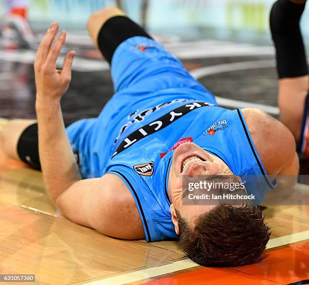 Kirk Penney of the Breakers grimmaces after falling heavily onto the court during the round 14 NBL match between the Cairns Taipans and the New...