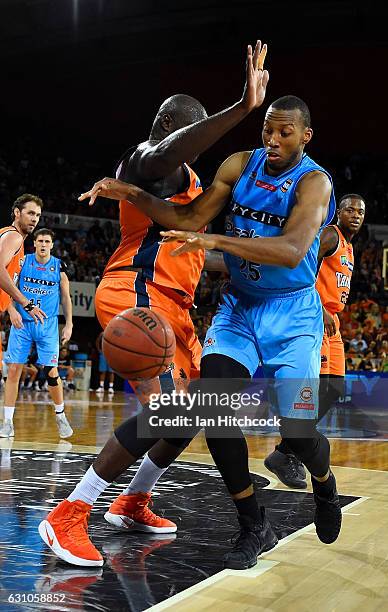Akil Mitchell of the Breakers contests the ball with Nathan Jawai of the Taipans during the round 14 NBL match between the Cairns Taipans and the New...