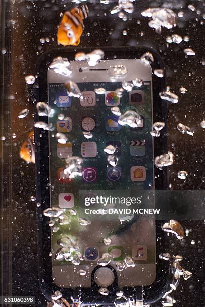 An iPhone in a waterproof Catalyst Case is displayed underwater at ShowStoppers during the 2017 Consumer Electronic Show in Las Vegas, Nevada on...