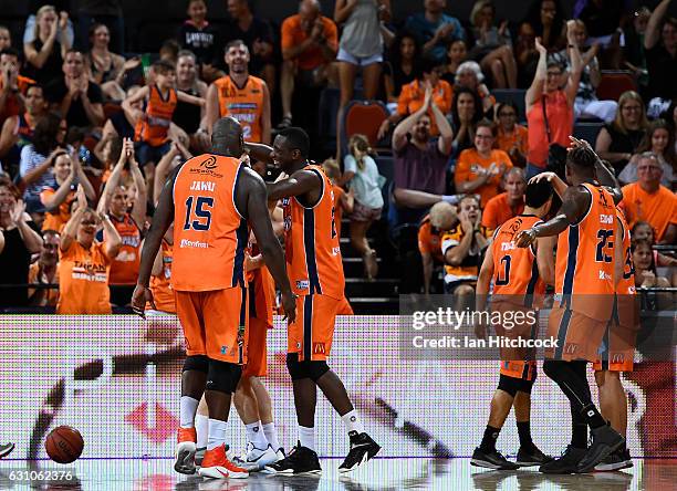 Taipans players celebrate after winning the round 14 NBL match between the Cairns Taipans and the New Zealand Breakers at Cairns Convention Centre on...