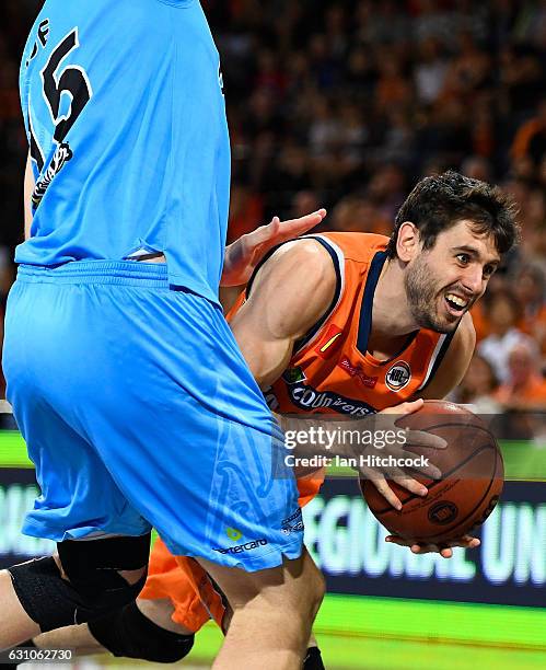 Jarrad Weeks of the Taipans is fouled by Rob Loe of the Breakers during the round 14 NBL match between the Cairns Taipans and the New Zealand...