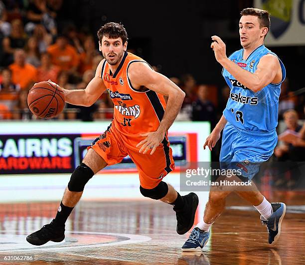 Jarrad Weeks of the Taipans gets past David Stockton of the Breakers during the round 14 NBL match between the Cairns Taipans and the New Zealand...