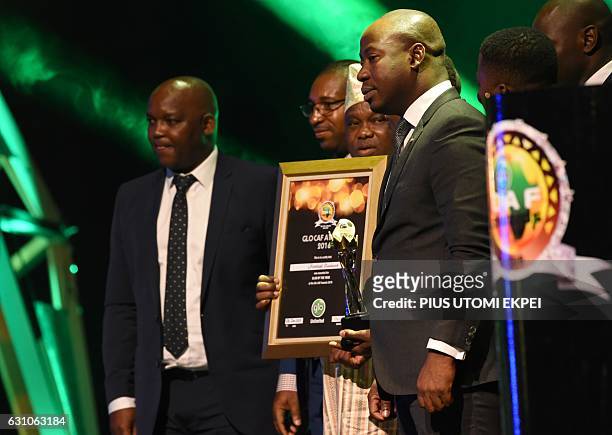 The Uganda national football team receives an award as African best national team during the African Footballer of the Year Awards in Abuja, on...