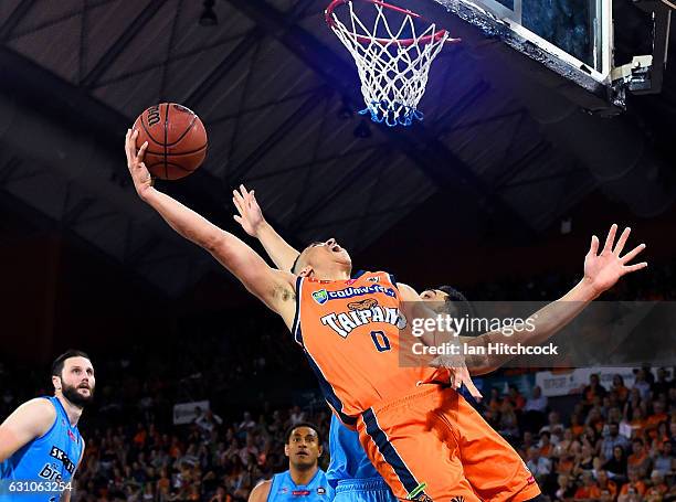 Travis Trice of the Taipans attempts a lay up over Shea Lli of the Breakers during the round 14 NBL match between the Cairns Taipans and the New...