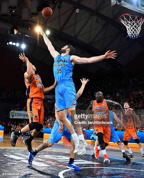 Alex Pledger of the Breakers attempts to block a shot of Travis Trice of the Taipans during the round 14 NBL match between the Cairns Taipans and the...