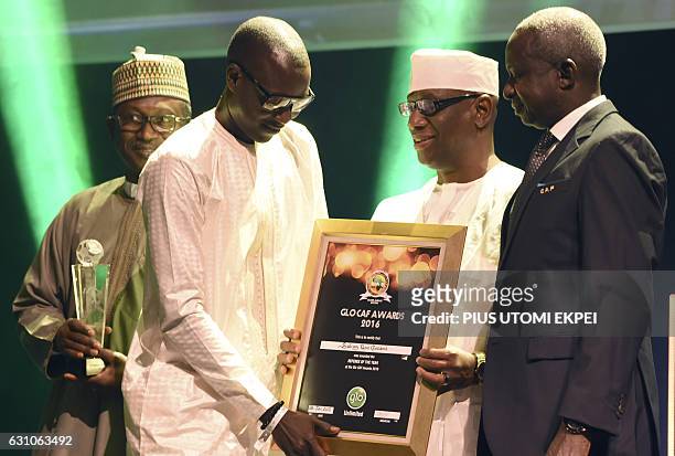 Referee of the Year Gambian Bakary Gassama receives his award during the African Footballer of the Year Awards in Abuja, on January 5, 2017. Algerian...