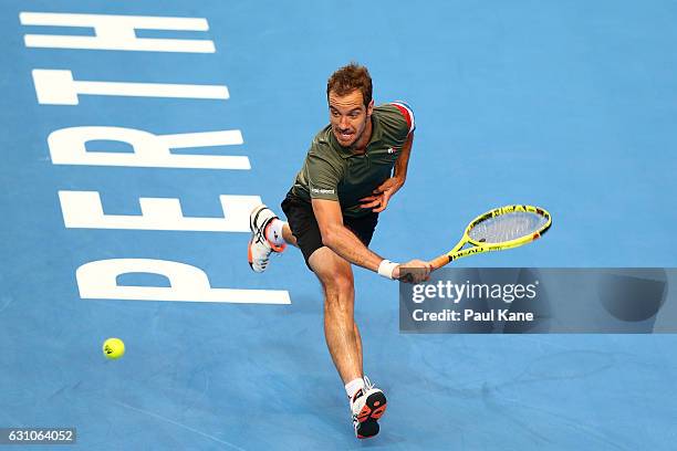 Richard Gasquet of France plays a backhand against Roger Federer of Switzerland in the men's singles match during day six of the 2017 Hopman Cup at...