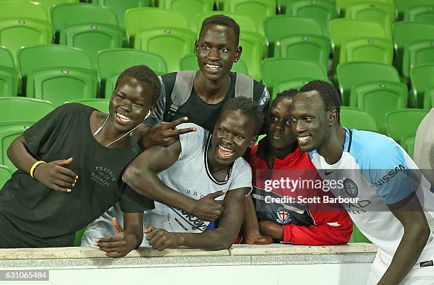City FC supporters from South Sudan celebrate the win with Ruon Tongyik of City FC during the round 14 A-League match between Melbourne City FC and...