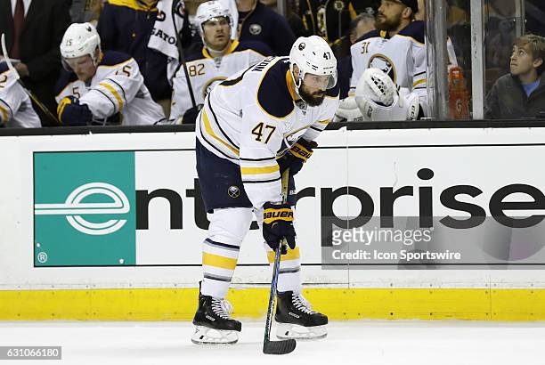 Buffalo Sabres defenseman Zach Bogosian gets set for the draw in the offensive zone during a regular season NHL game between the Boston Bruins and...