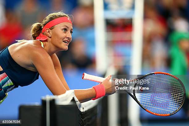 Kristina Mladenovic of France leans across the net after a shot to Belinda Bencic of Switzerland in the women's singles match during day six of the...