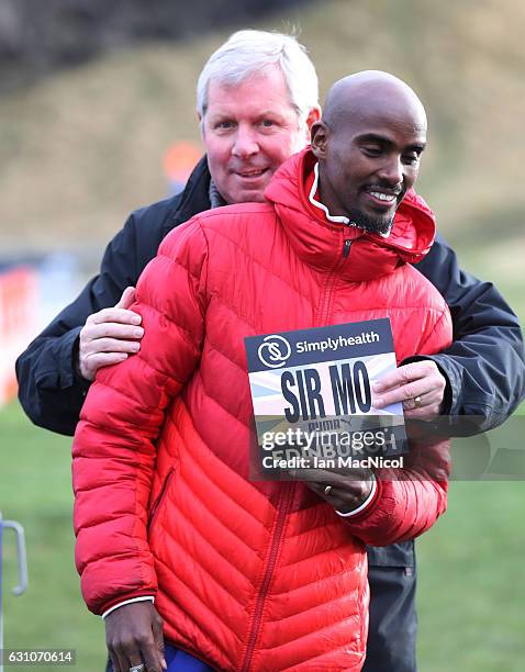 Sir Mo Farah poses for photographs with Bredan Foster in Holyrood Park prior to tomorrow's Great Edinburgh X Country on January 6, 2017 in Edinburgh,...