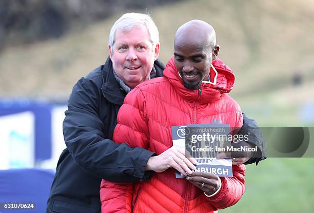 Sir Mo Farah poses for photographs with Bredan Foster in Holyrood Park prior to tomorrow's Great Edinburgh X Country on January 6, 2017 in Edinburgh,...