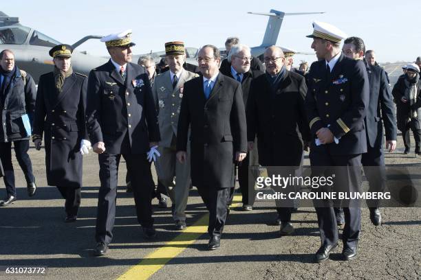 French President Francois Hollande , flanked by French Defence Minister Jean-Yves Le Drian , French Junior Minister for Veterans and Remembrance...