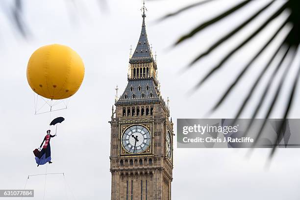 Greenpeace activists float a picture of Mary Poppins wearing a gas mask in front of the Houses of Parliament to highlight that London has breached...