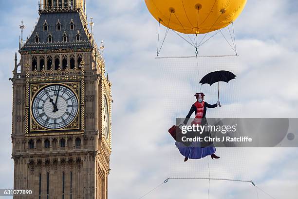 Greenpeace activists float a picture of Mary Poppins wearing a gas mask in front of the Houses of Parliament to highlight that London has breached...