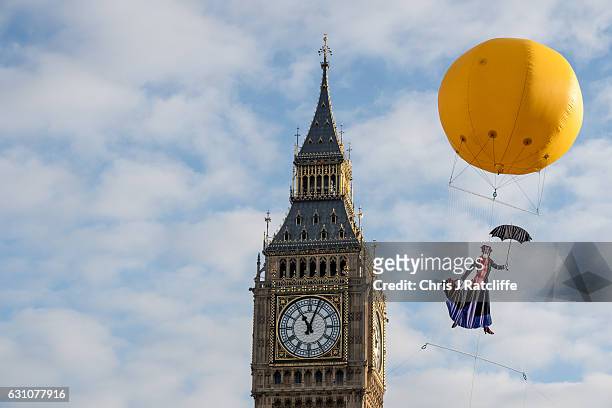Greenpeace activists float a picture of Mary Poppins wearing a gas mask in front of the Houses of Parliament to highlight that London has breached...
