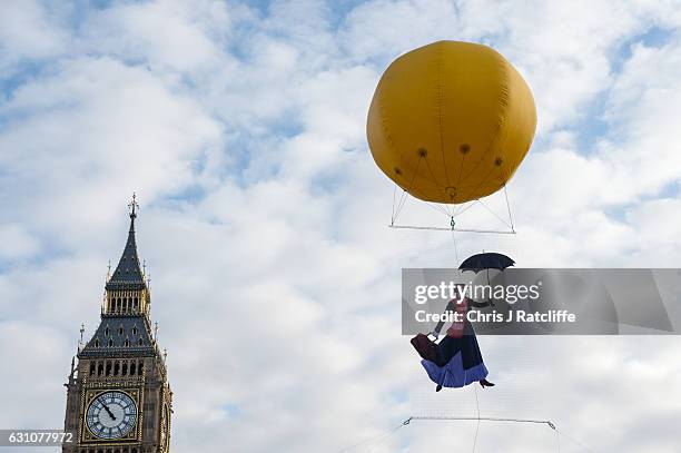 Greenpeace activists float a picture of Mary Poppins wearing a gas mask in front of the Houses of Parliament to highlight that London has breached...