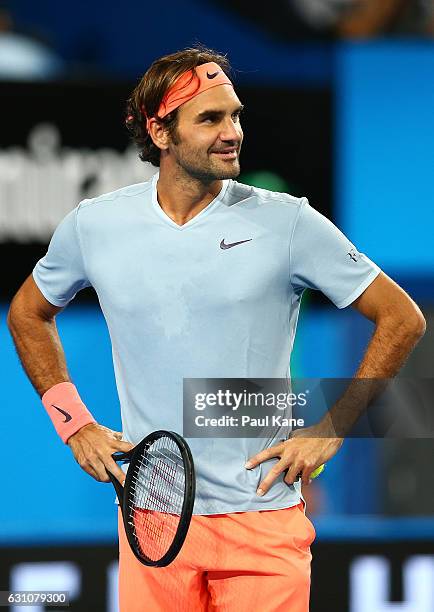 Roger Federer of Switzerland partnered with Belinda Bencic looks on during the mixed doubles match against Richard Gasquet and Kristina Mladenovic of...