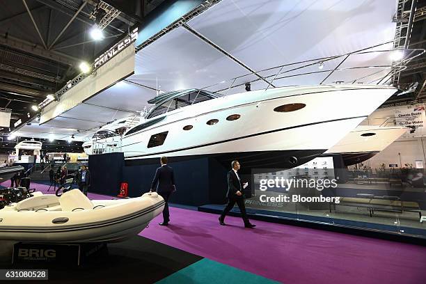 Visitors pass a yacht, manufactured by Princess Yachts International Plc, at the London Boat Show in London, U.K., on Friday, Jan. 6, 2017. Boats are...