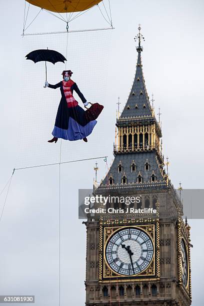 Greenpeace activists float a picture of Mary Poppins wearing a gas mask in front of the Houses of Parliament to highlight that London has breached...