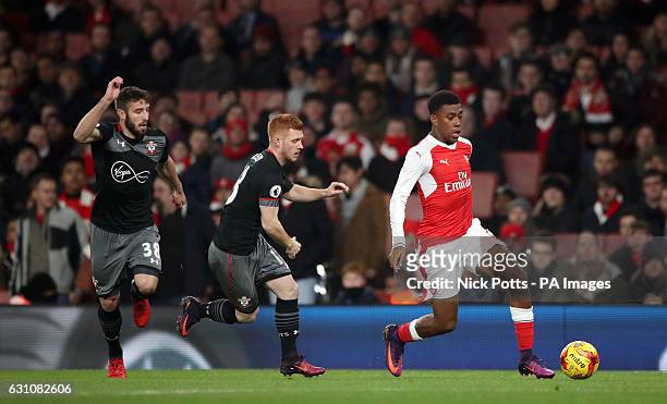 Arsenal's Alex Iwobi leaves behind Southampton's Sam McQueen and Harrison Reed