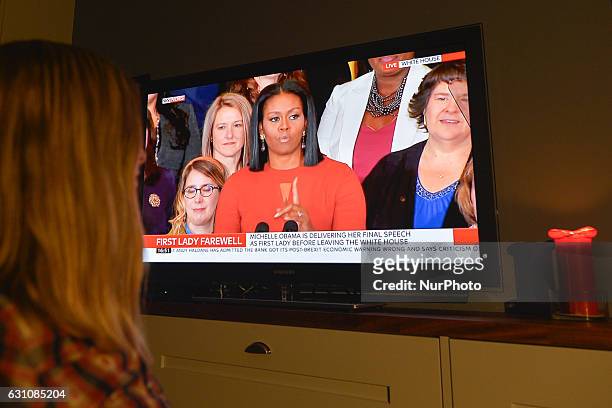 An Irish woman watches Michelle Obama as she delivers her final speech as first lady on Friday, 6 January 2017 in Dublin, Ireland.