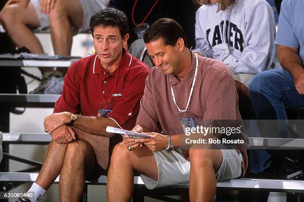 High School Basketball: 16th Nike All-American Camp: Louisville coach Rick Pitino and Memphis coach John Calipari seated in stands during game at...