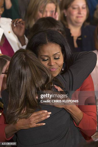 First Lady Michelle Obama hugs Terri Tchorzynski, a school counselor at the Calhoun Area Career Center, winner of a national School Counselor of the...