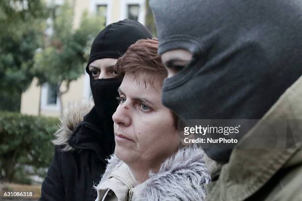 Paula Roupa is escorted by anti-terrorist police officers coming out of the offices of prosecutors in a court in Athens, on Friday January 6, 2017....