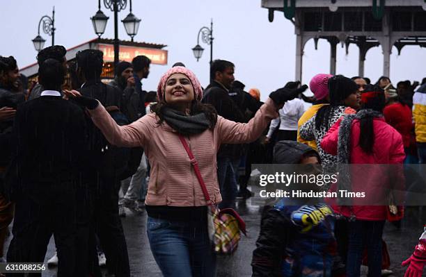 Girl enjoying the light rain and sleet in the evening at Ridge, on January 6, 2017 in Shimla, India.