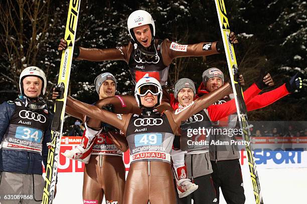 Kamil Stoch of Poland celebrates victory with his team mate Piotr Zyla ( and others after the final round on Day 2 of the 65th Four Hills Tournament...