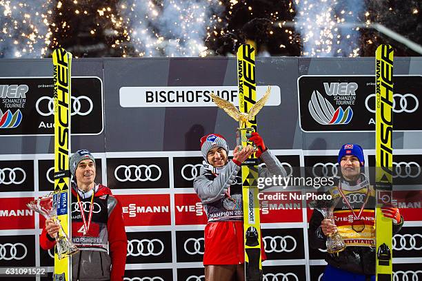 Kamil Stoch of Poland celebrates winning the 65th Four Hills Tournament ski jumping event with Daniel Andre Tande of Norway and Piotr Zyla of Poland...