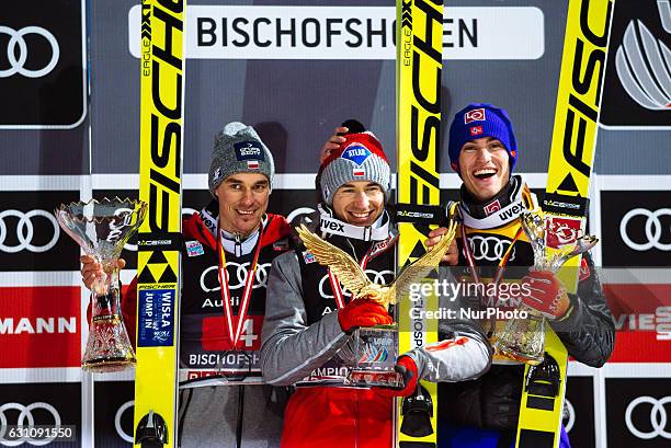 Kamil Stoch of Poland celebrates winning the 65th Four Hills Tournament ski jumping event with Daniel Andre Tande of Norway and Piotr Zyla of Poland...