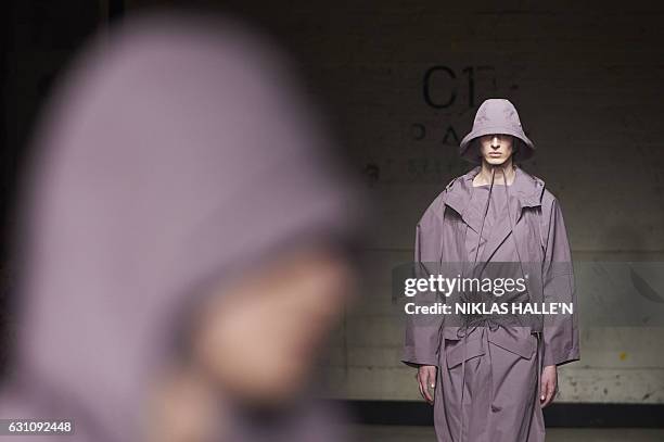 Models present creations by British designer Craig Green on the first day of the Autumn/Winter 2017 London Fashion Week Men's fashion event in London...