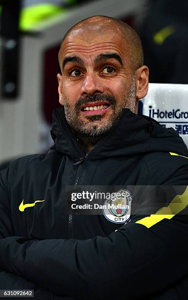 Josep Guardiola, Manager of Manchester City looks on during The Emirates FA Cup Third Round match between West Ham United and Manchester City at...