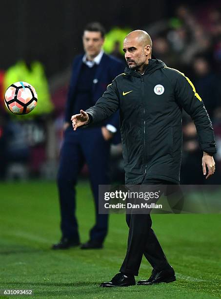 Josep Guardiola, Manager of Manchester City throws the ball back into play during The Emirates FA Cup Third Round match between West Ham United and...