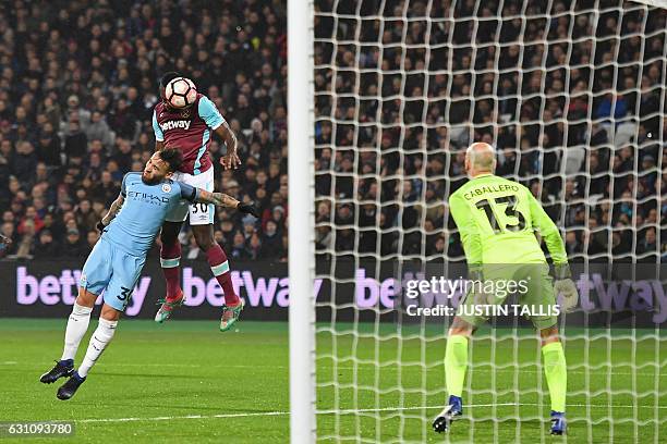 West Ham United's English midfielder Michail Antonio beats Manchester City's Argentinian defender Nicolas Otamendi to the ball but his header goes...