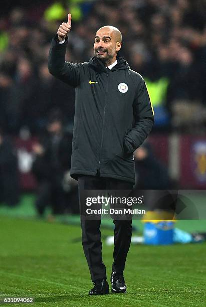 Josep Guardiola, Manager of Manchester City looks on during The Emirates FA Cup Third Round match between West Ham United and Manchester City at...