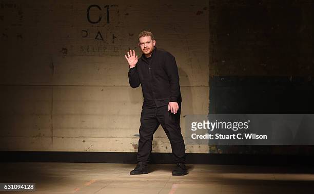 Craig Green gestures to guests following his runway show during London Fashion Week Men's January 2017 collections at Topman Show Space on January 6,...