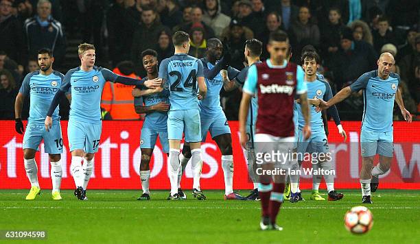 Yaya Toure of Manchester City celebrates with team mates after scoring his sides first goal during The Emirates FA Cup Third Round match between West...